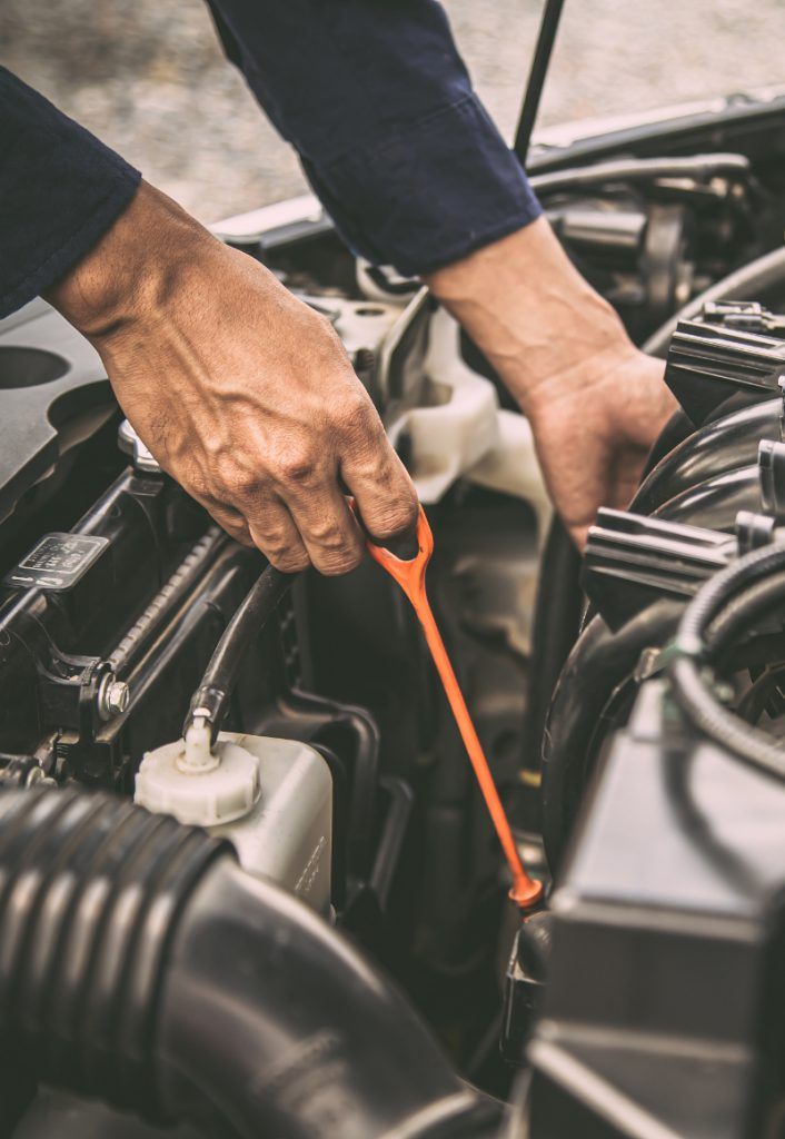 Mechanic checking the oil of a vehicle - Car Service West Bromwich