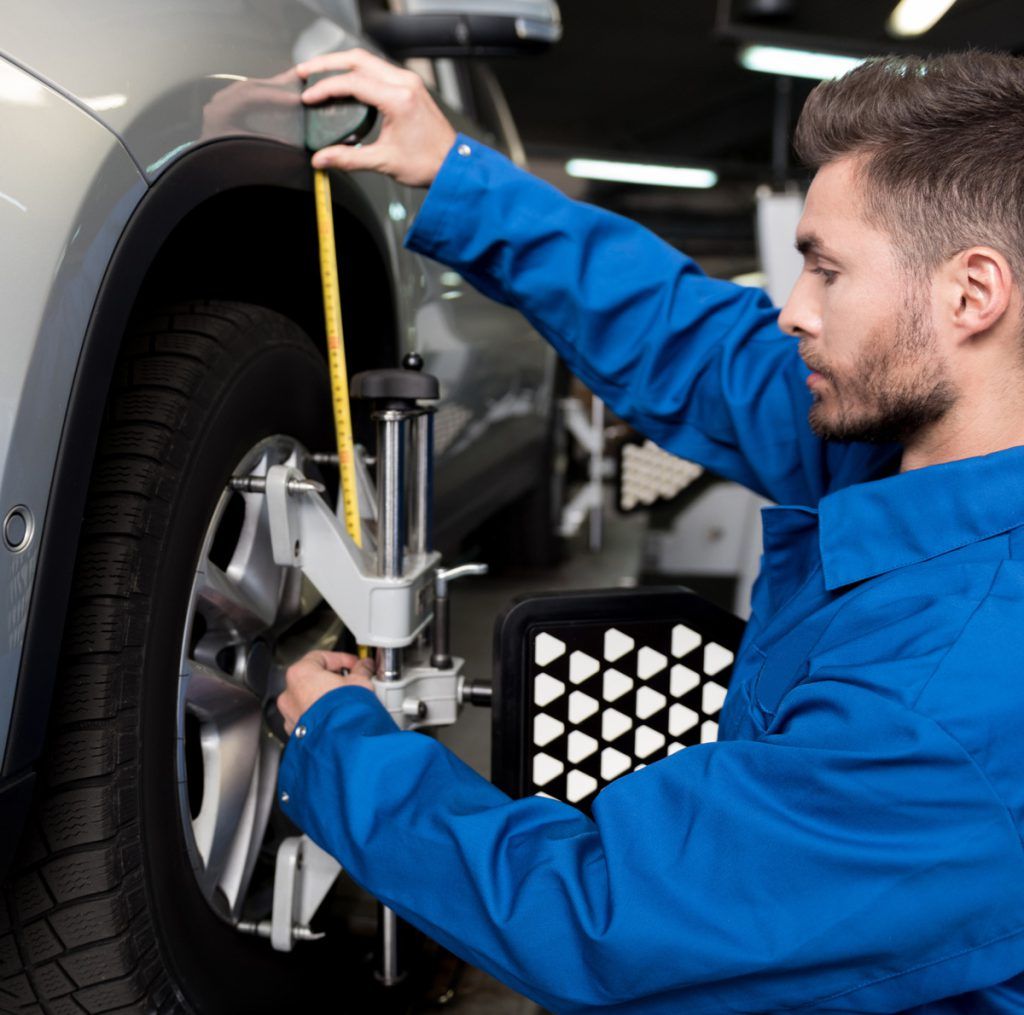 Mechanic checking a vehicle for its wheels - Wheel Alignment West Bromwich